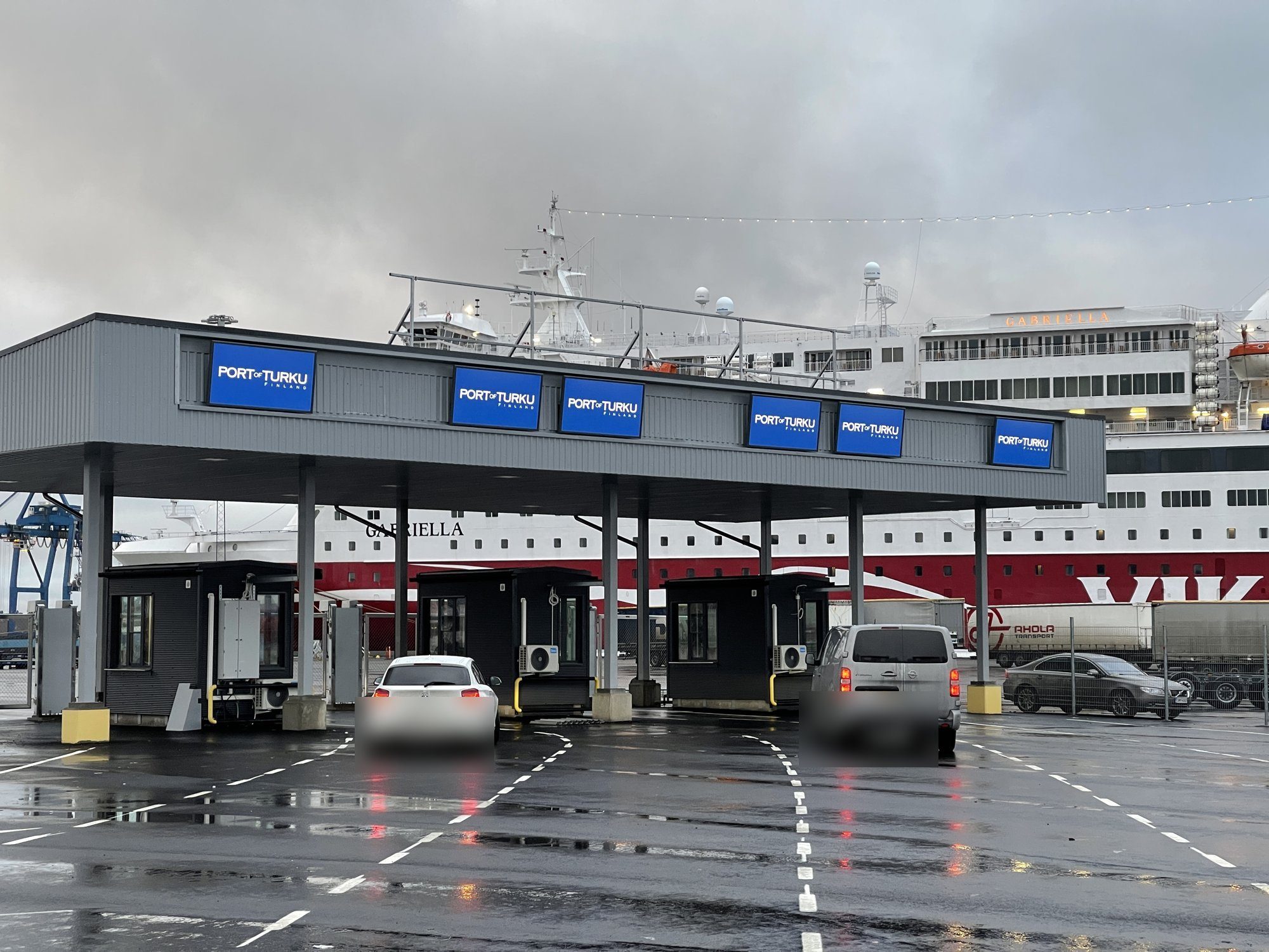Ferry check-in canopy at the Port of Turku with six Ampron DR-2000x1040 LED boards along the fascia and a ferry at berth behind