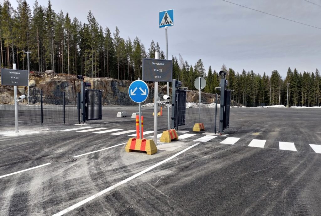 Ampron outdoor LED display inside Visy Access Gate installation at Tokmanni's Mäntsälä distribution centre — driver-facing routing message board for unmanned gate operations